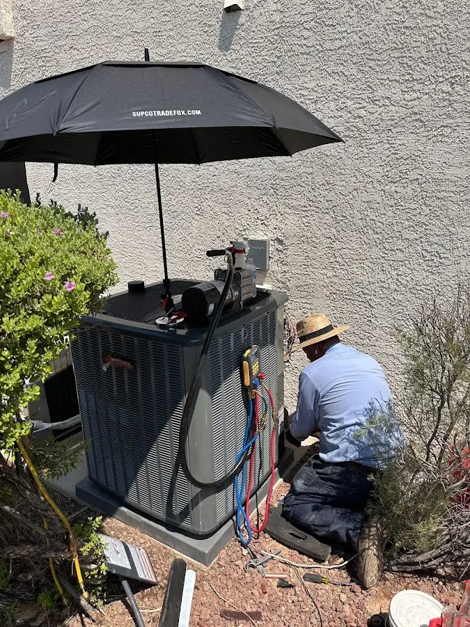 HVAC technician performing outdoor AC maintenance in Middletown